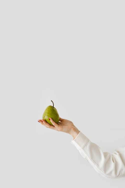 A Person Holding a Green Pear