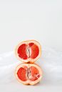 Sliced Orange Fruit on White Textile