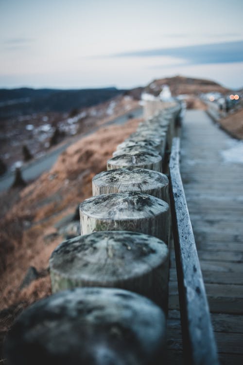 Free Wooden footbridge on grassy hill at sundown Stock Photo