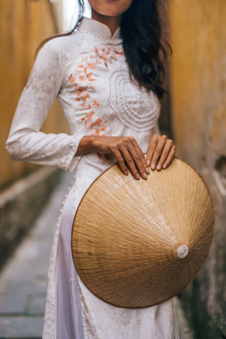 Person Holding A Rice Hat