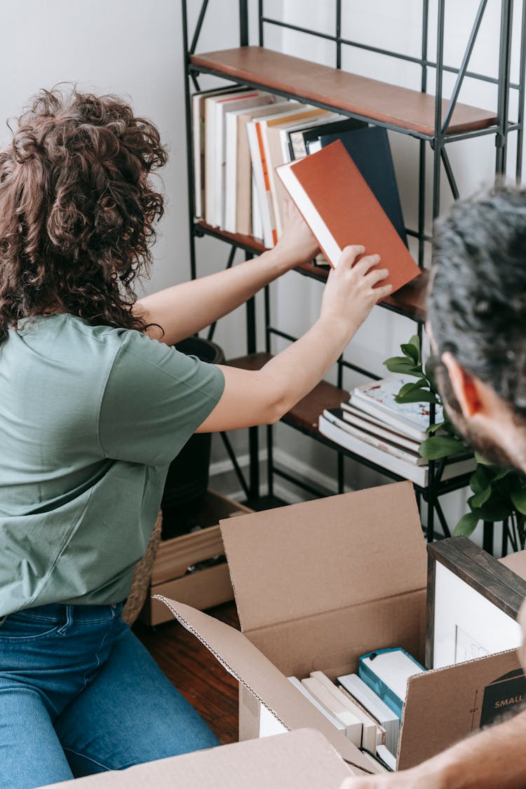 Couple Packing Up Books