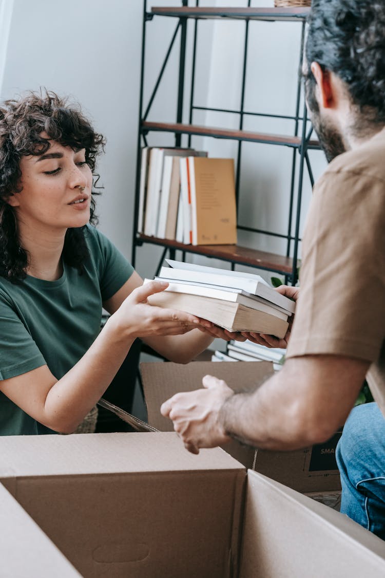 Couple Packing Up Books