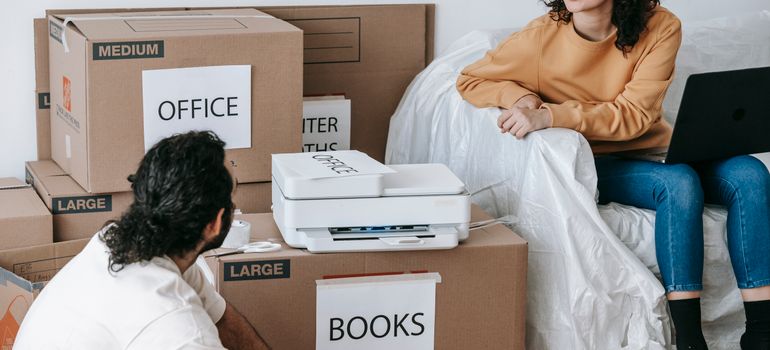 Couple surrounded by labelled moving boxes