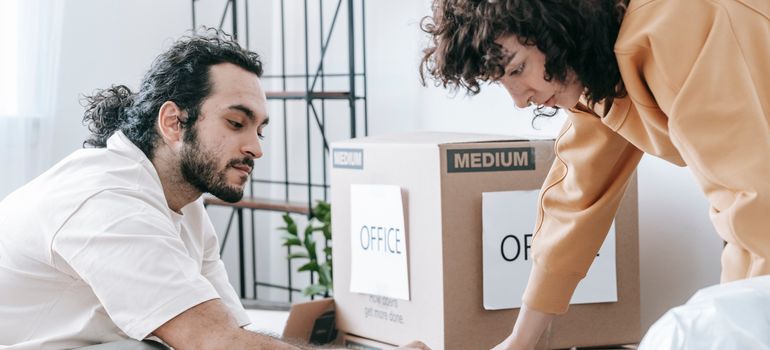 People labeling boxes for an office move