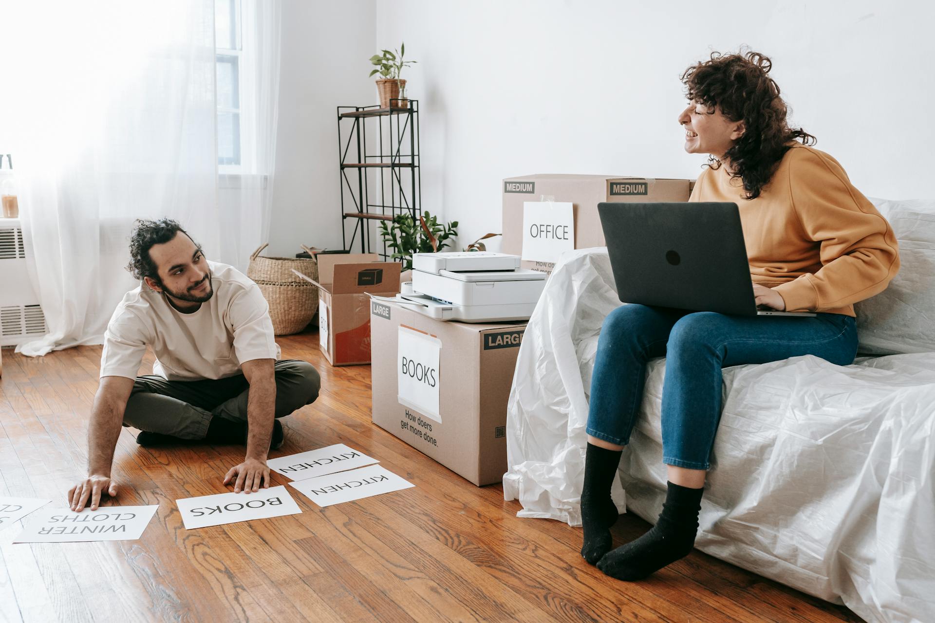 Couple Making Printed Labels For Boxes