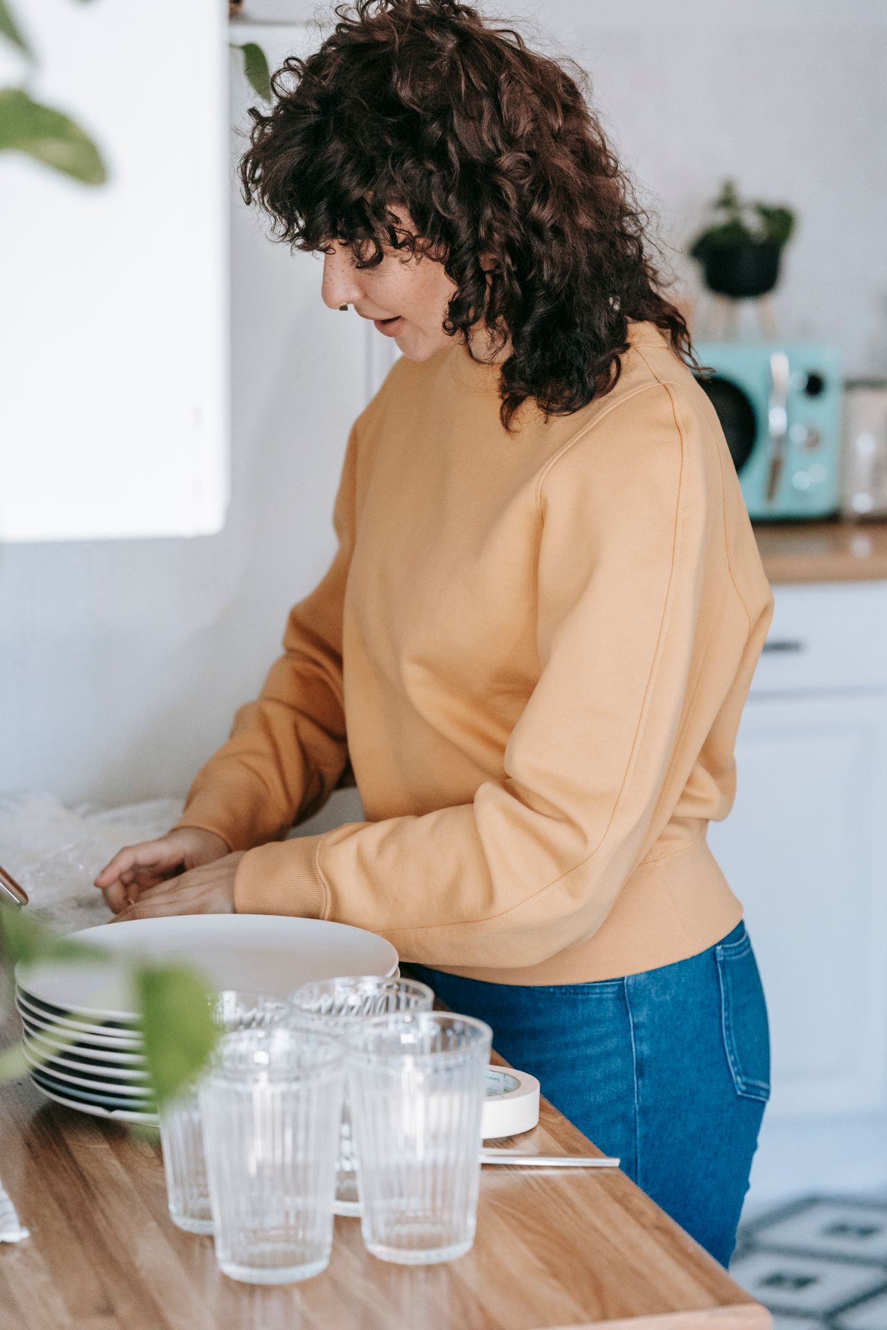 Woman sorting household items at the start of a decluttering session