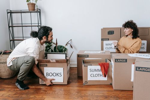 Free A couple sorting boxes and preparing for a move in their new home. Stock Photo