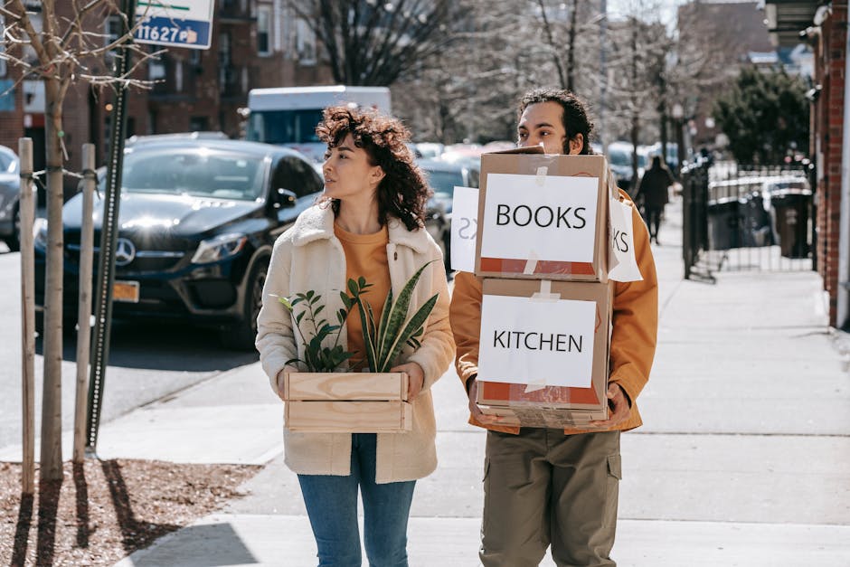 A person walking through a park carrying a small notebook, practicing mindful grocery planning to support emotional well-being during housing transitions.. Lens: Blue Bird