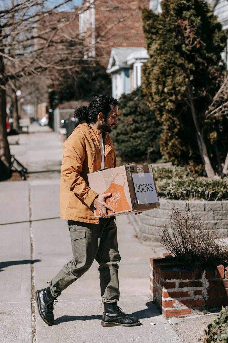 Man Carrying A Box Of Books