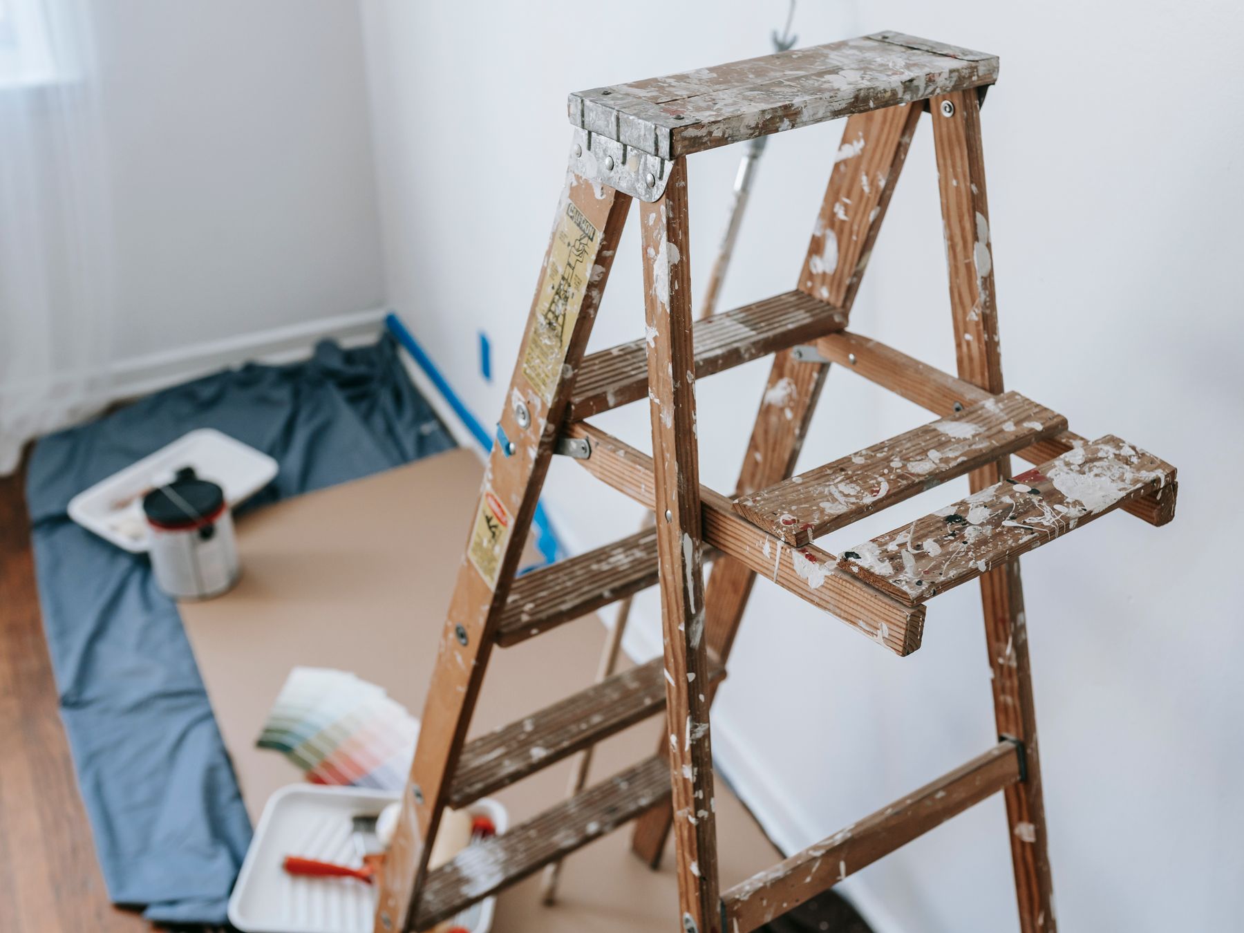 Stepladder, dust sheets and prep tools set up for decorating
