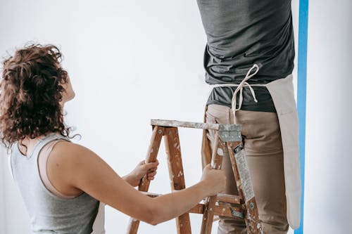 Woman Holding A Stepladder