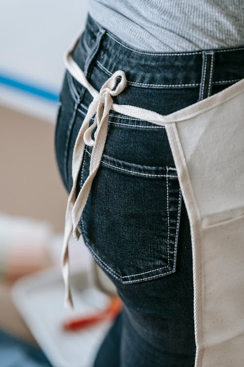 Free Crop Photo Of Woman Wearing Denim Pants With Apron Stock Photo