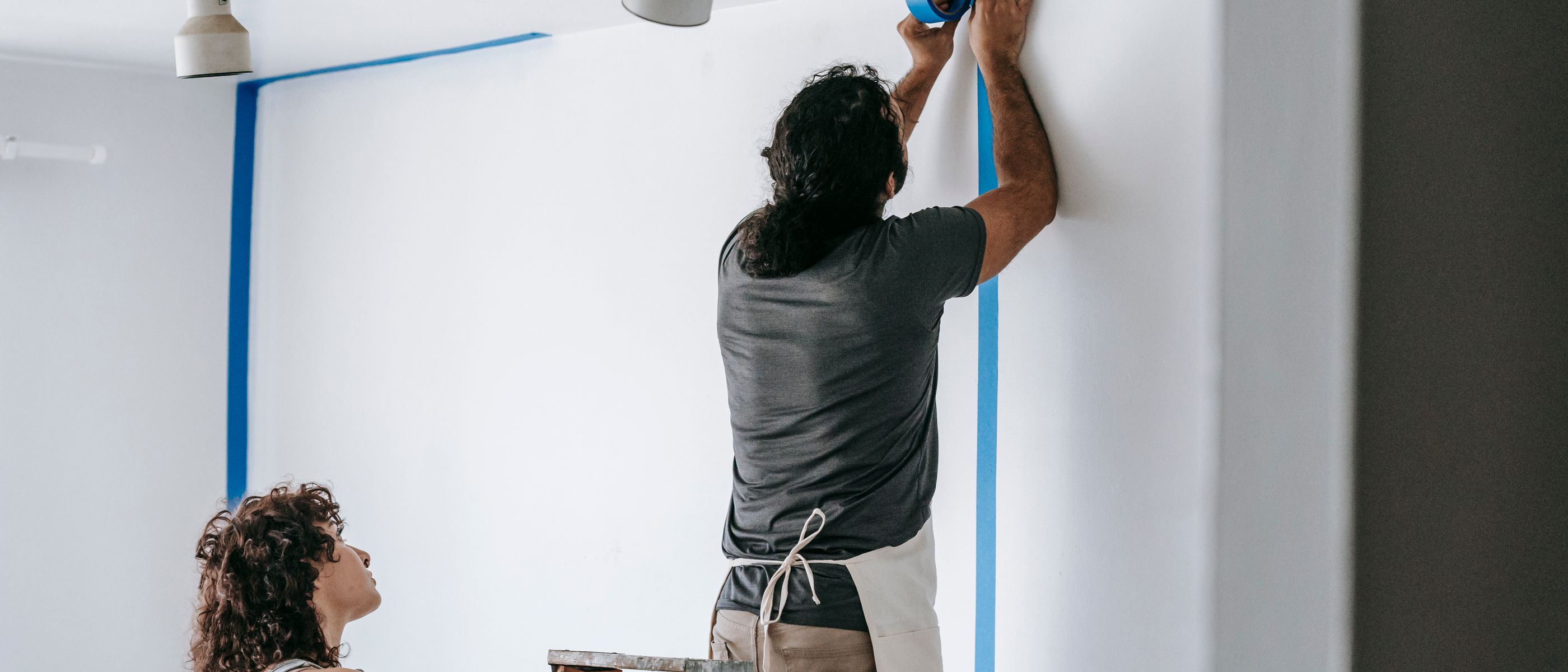 Wallpapering in Albany Park — careful masking before painting begins