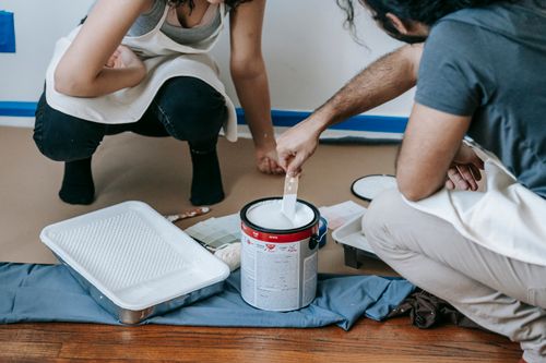 Free A couple paints their new home together, preparing walls for a fresh look. Stock Photo