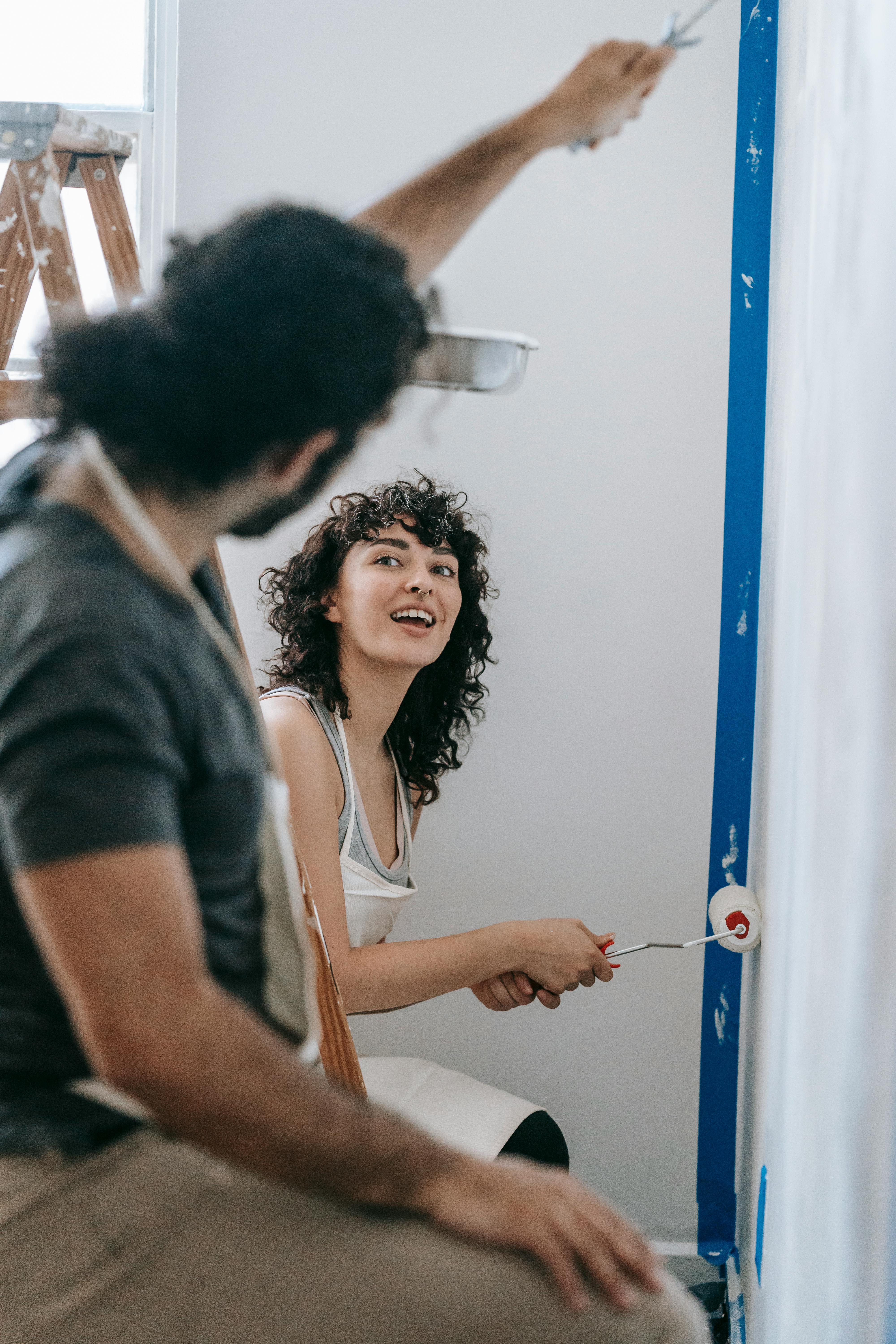 a couple painting a wall