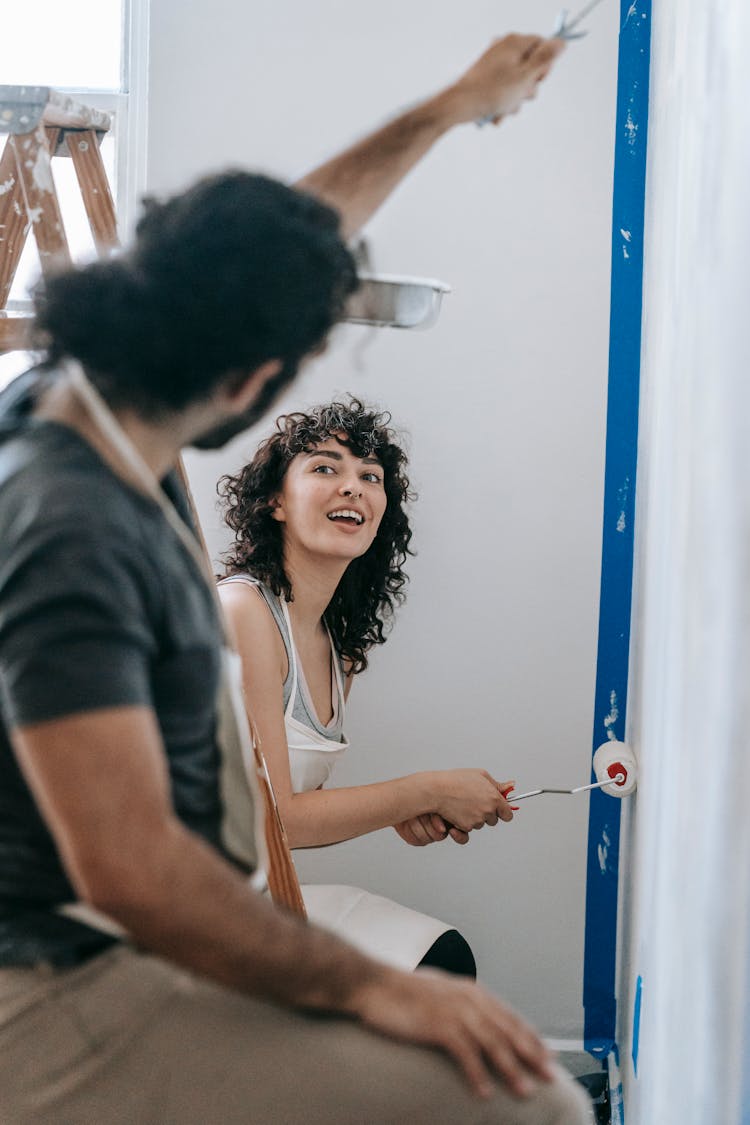 A Couple Painting A Wall