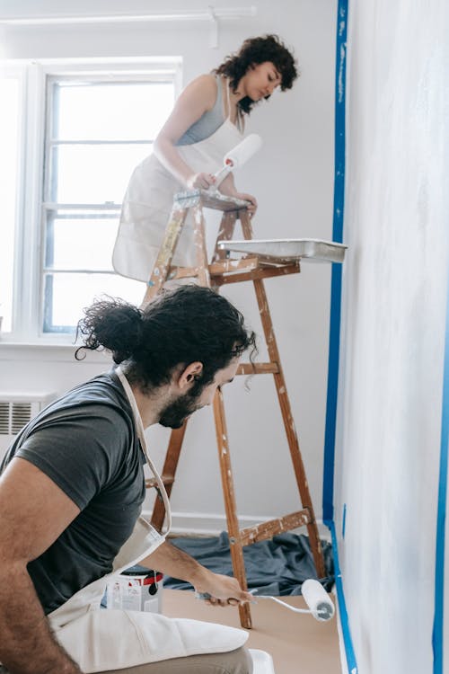 A Couple Painting The Wall