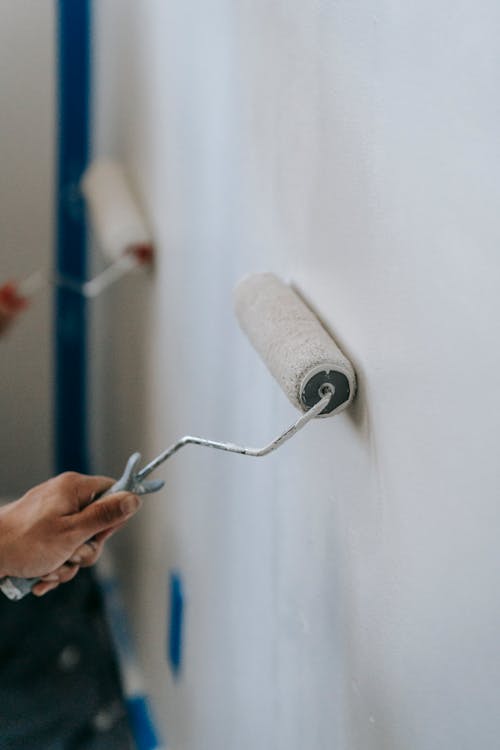 People Painting The Wall