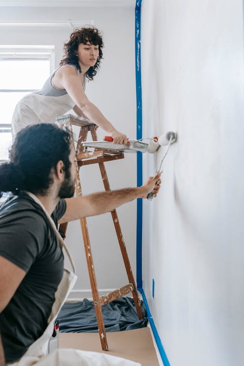 Free A Couple Painting The Wall Stock Photo