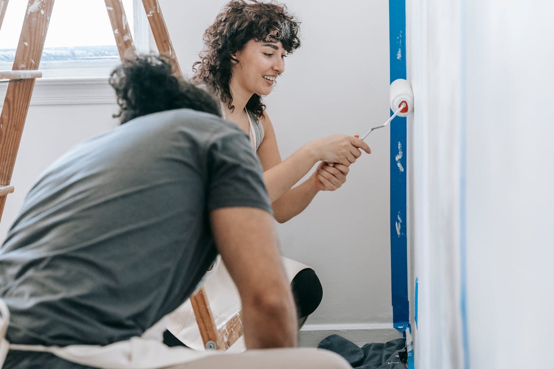 Woman Painting The Wall · Free Stock Photo