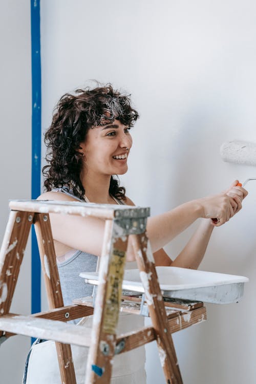 Woman Painting The Wall