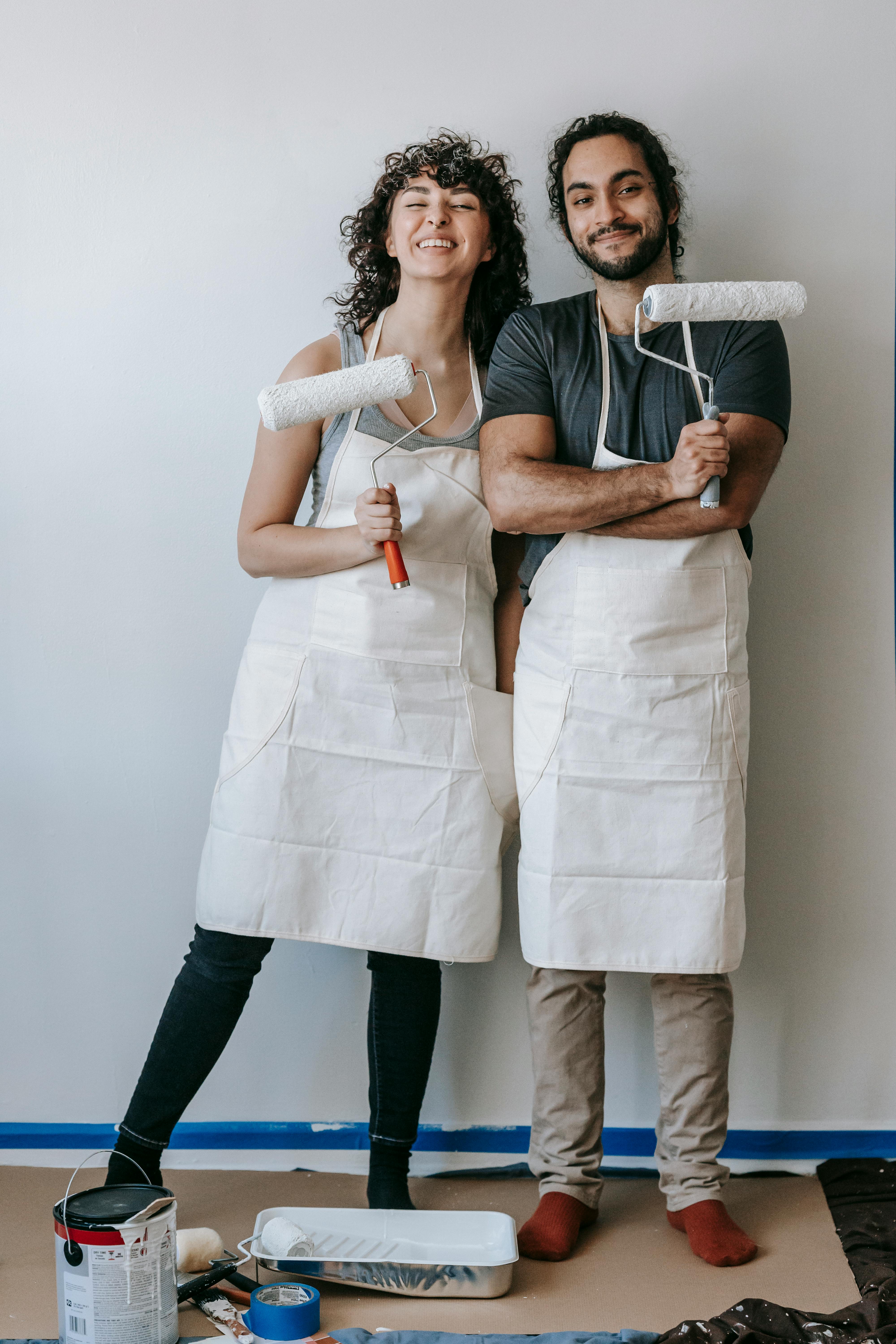 Two People Holding Paint Rollers · Free Stock Photo