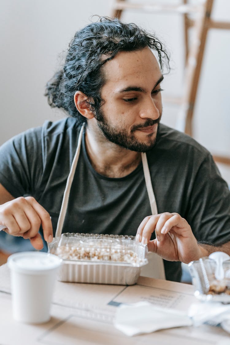 Man With Packed Food On Table