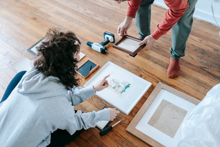 Couple Arranging Picture Frames