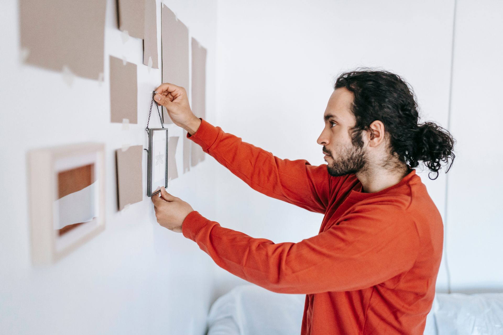Man Removing A Frame From Wall