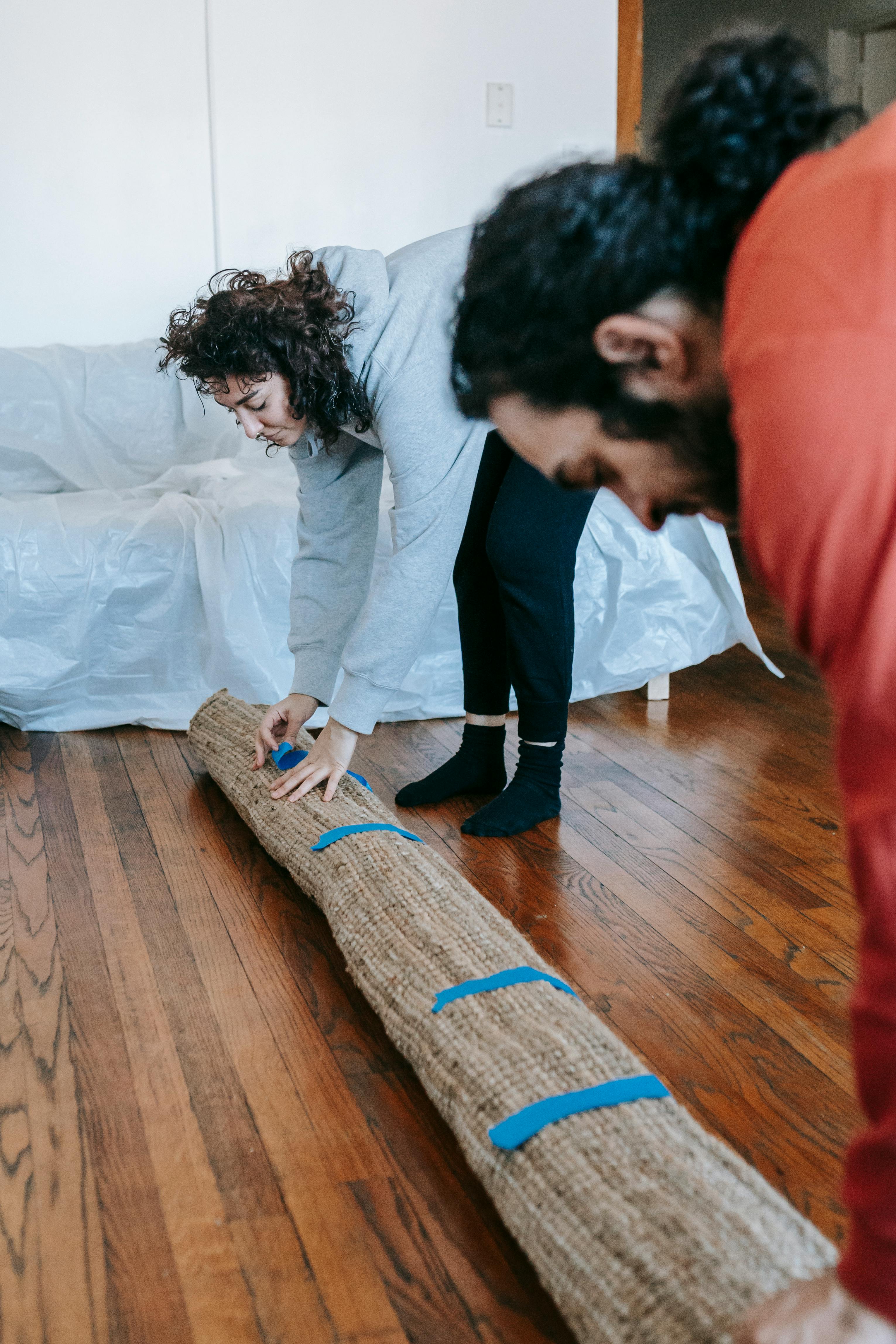 couple packing up a carpet