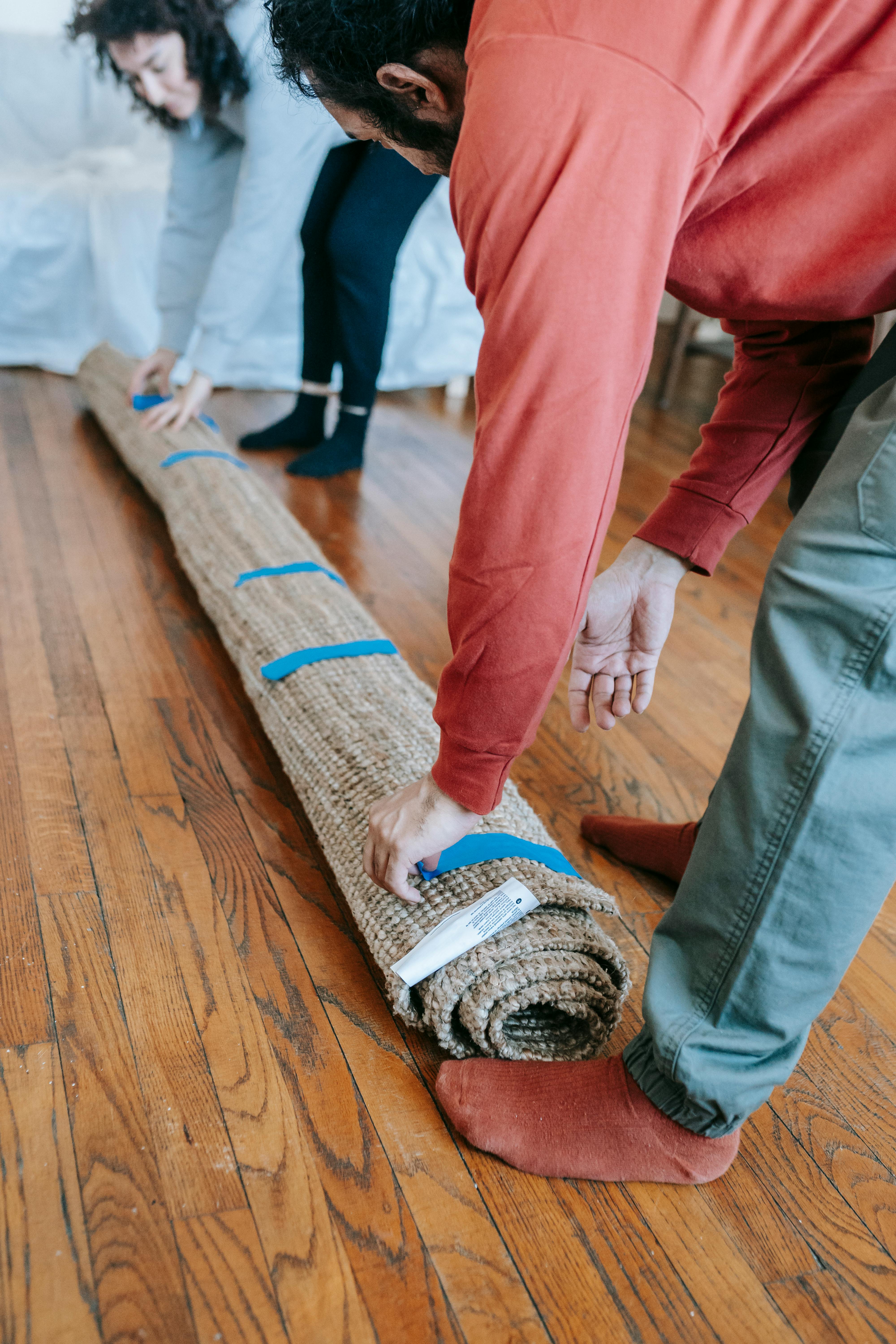 couple packing up a carpet