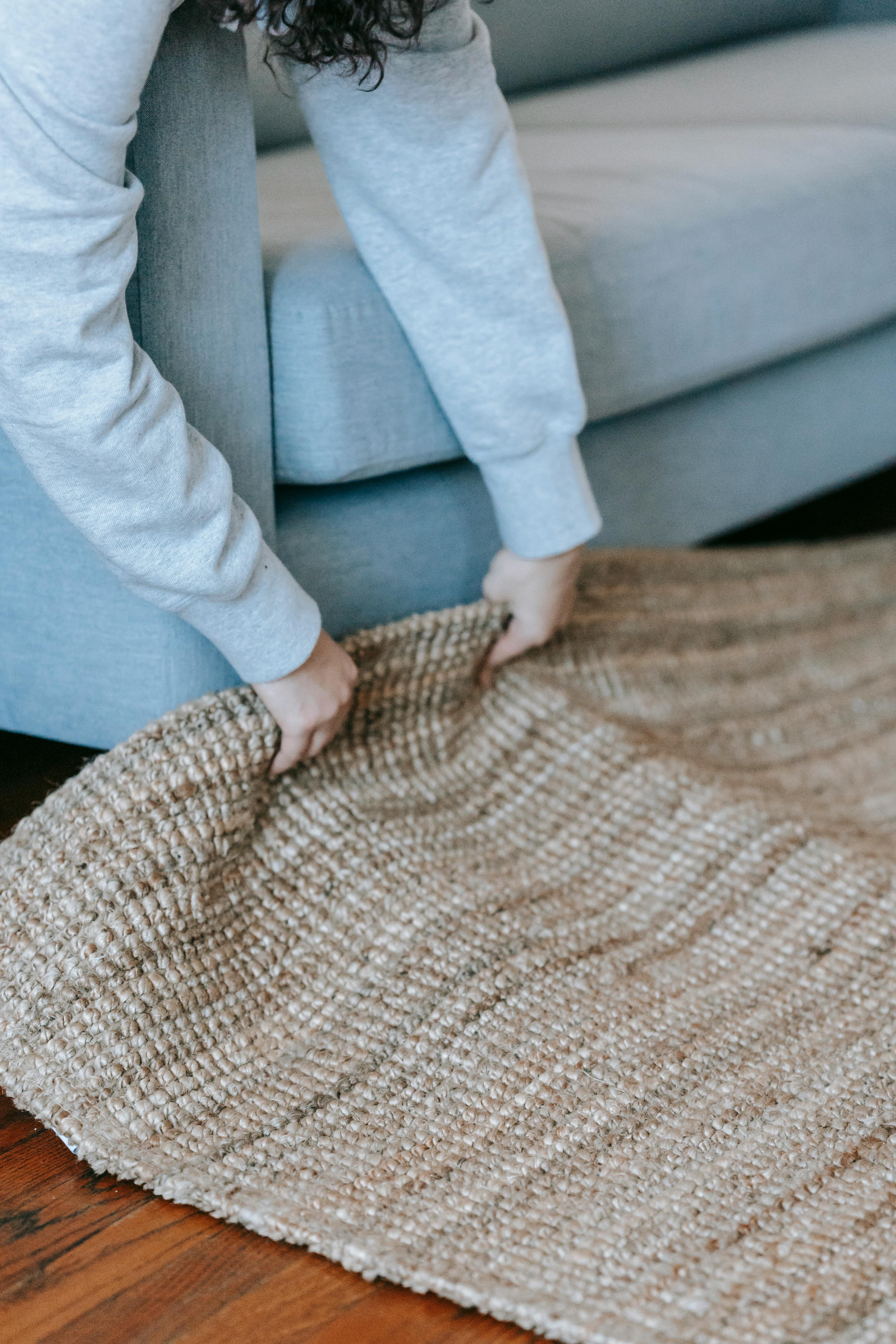 Person Lifting Up A Carpet · Free Stock Photo