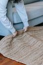 Person Lifting Up A Carpet