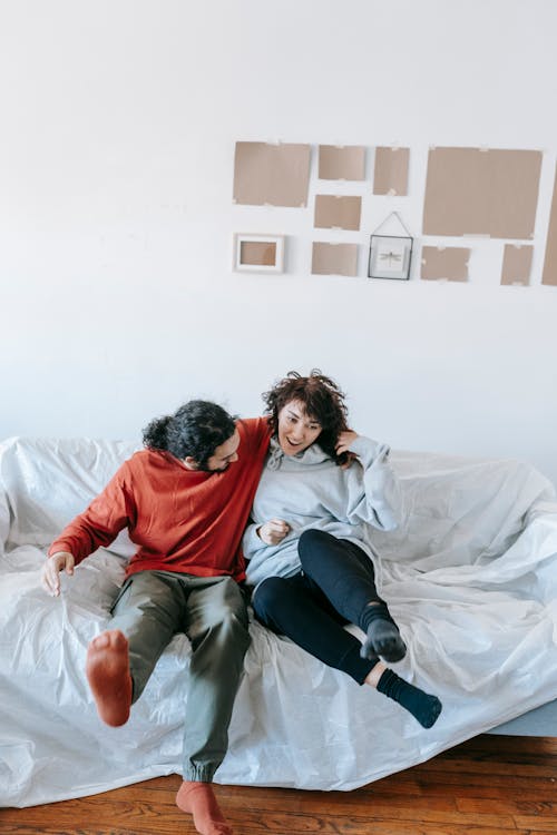 Couple Having Fun While Sitting On A Sofa