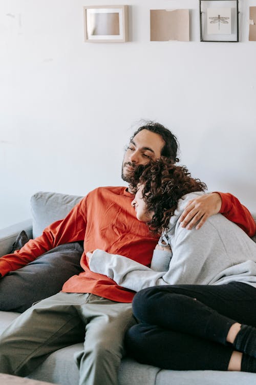 Free A Couple Relaxing On A Couch Stock Photo