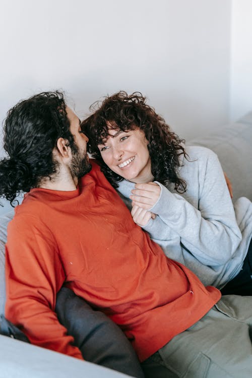 Free Happy Couple Sitting On A Couch Stock Photo