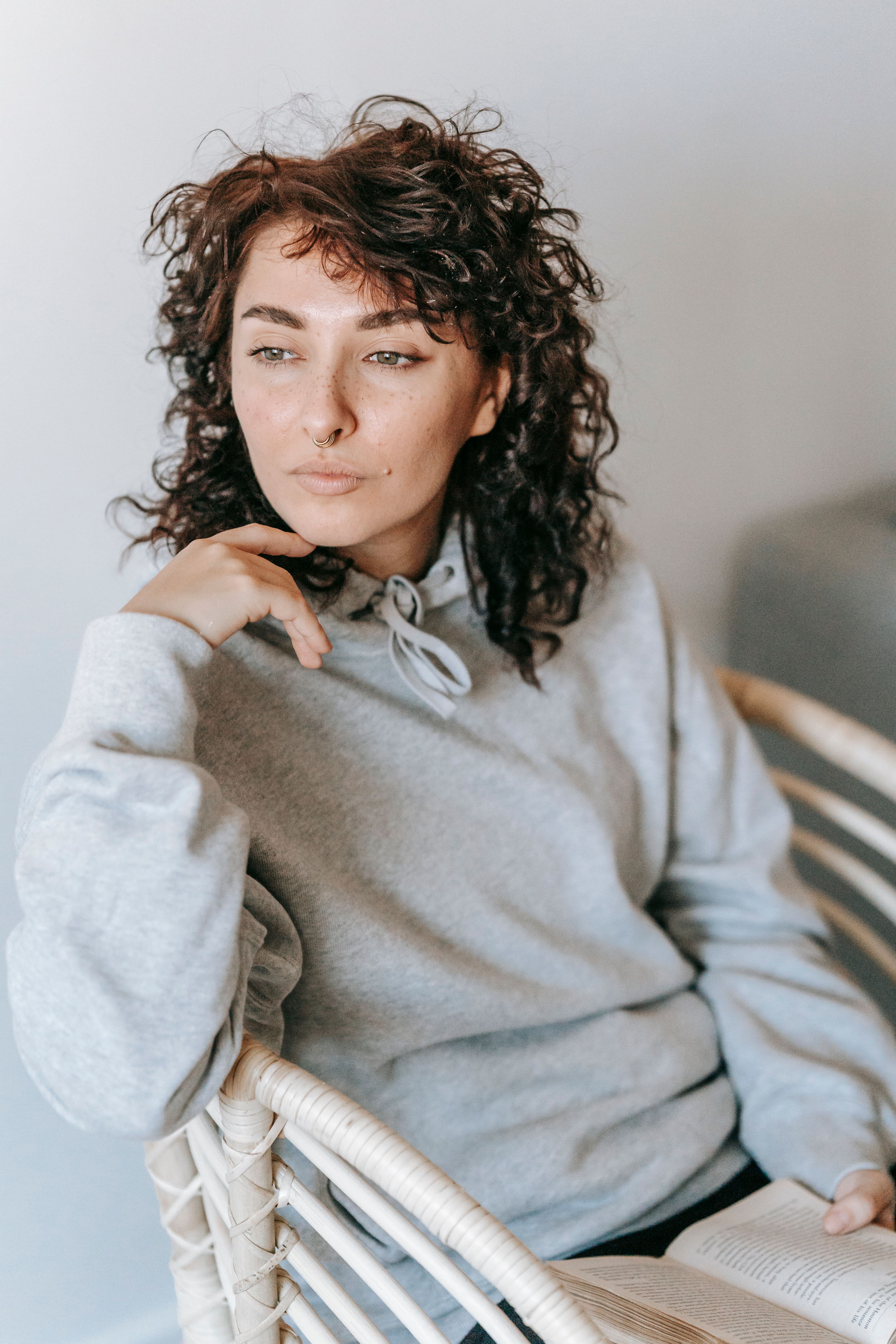 Woman Sitting On A Wicker Chair · Free Stock Photo