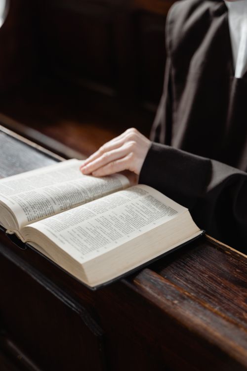 Free A nun reading a holy book inside a church, embracing spirituality and faith. Stock Photo