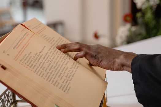 A close-up of a hand reading a religious text, symbolizing engaged spirituality.