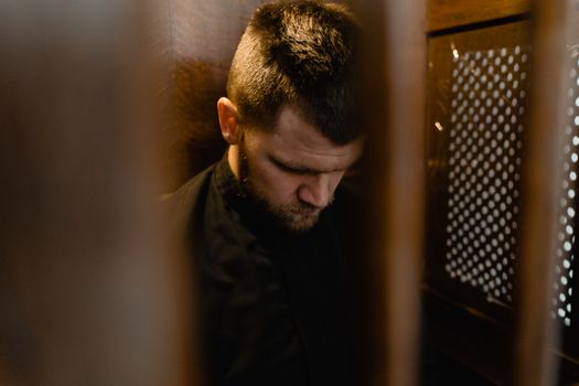 Photo of a Priest in a Confessional
