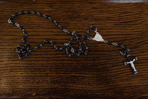 Free Silver Chain Necklace on Brown Wooden Table Stock Photo