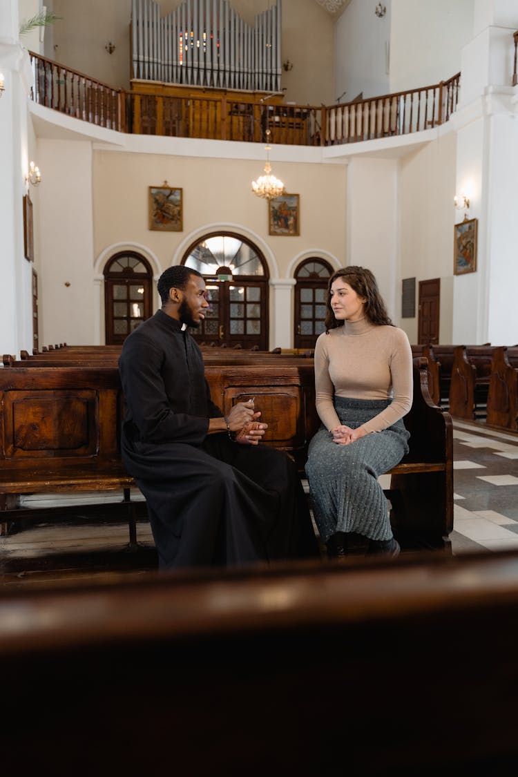 A Woman And A Priest Talking