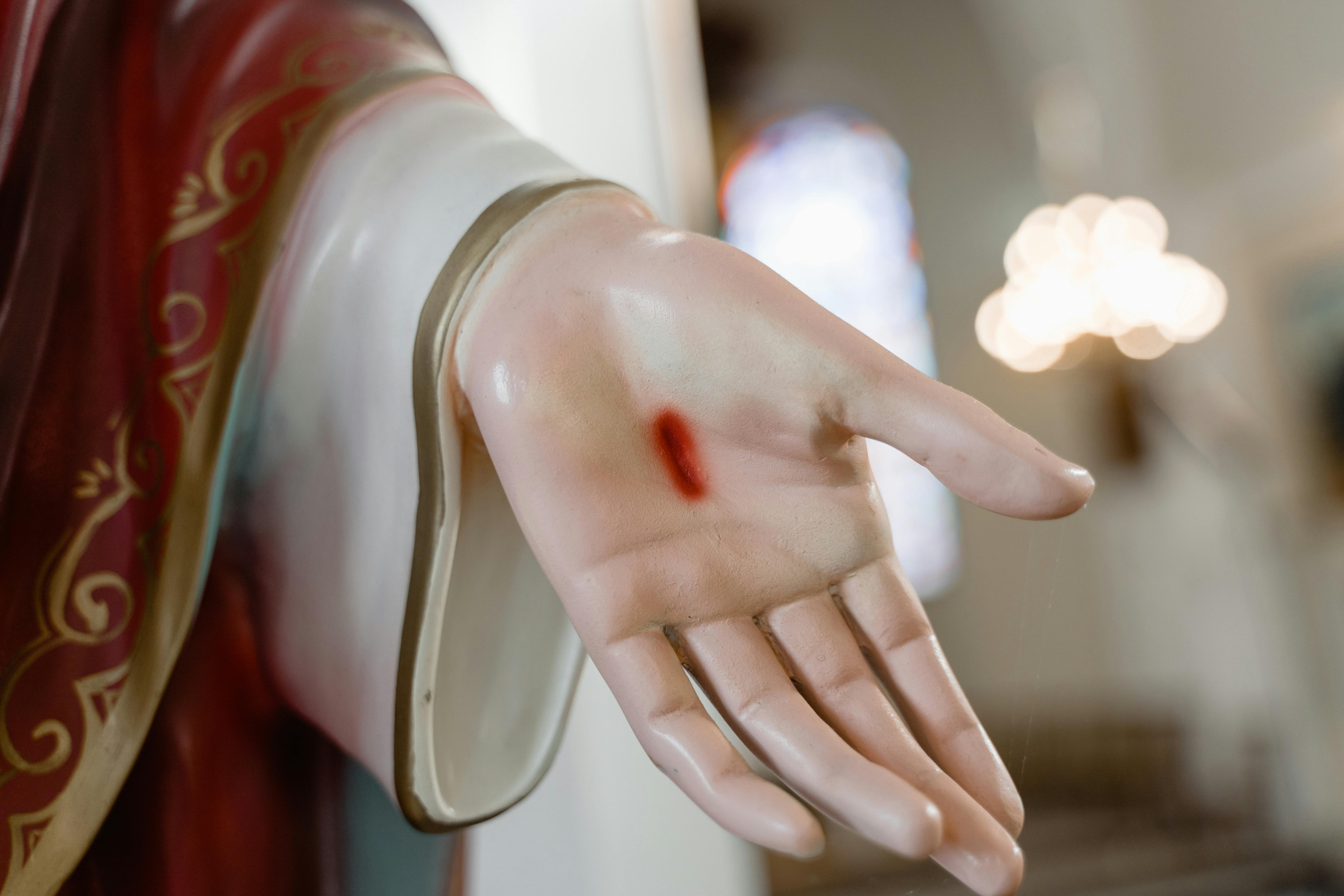 person in red long sleeve shirt holding womans hand