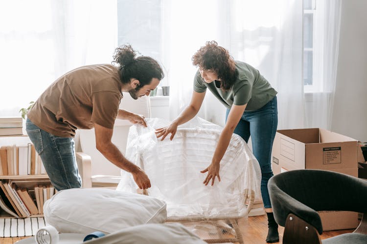 Couple Packing Up A Chair