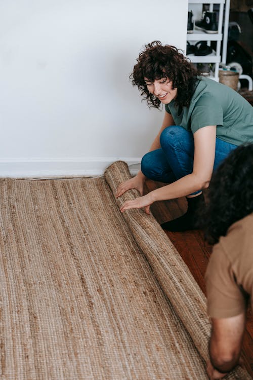 Free Couple Rolling Out A Carpet Stock Photo