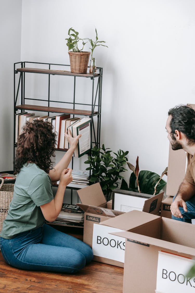 Woman Packing Books In A Box