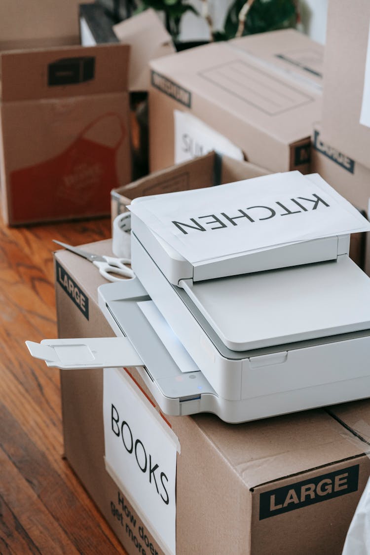 A Printer On A Box Of Books