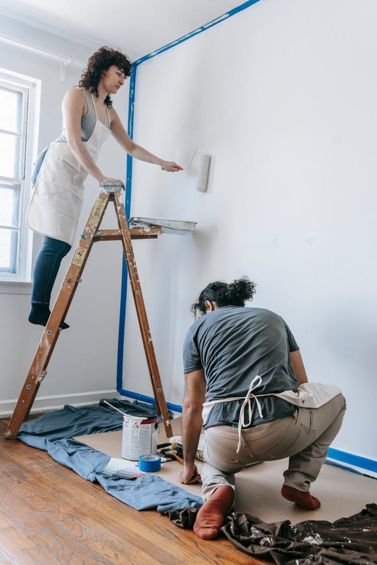 Couple Painting A Wall