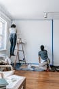 A Couple Painting A Wall