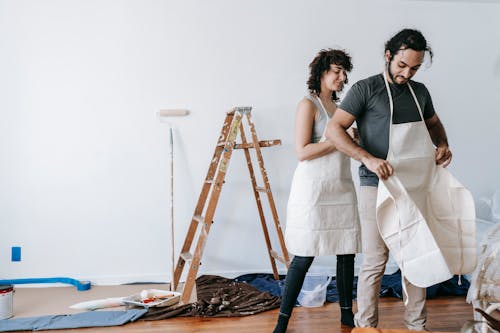 A Couple Wearing Aprons Before Painting